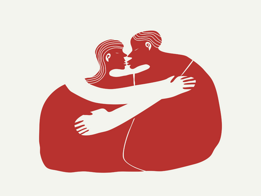 Ilustracja w minimalistycznym stylu – para osób siedzi naprzeciwko siebie w objęciach, tworząc zarys wspólnej sylwetki w kolorze czerwonym. Postacie mają białe ramiona i zbliżone do siebie twarze, co symbolizuje bliskość i emocjonalną więź.