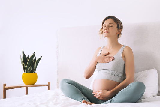 Kobieta w ciąży próbuję technik oddechu w ramach przygotowania do hipnoporodu