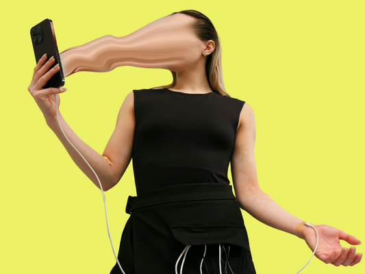 Osoba robiąca selfie ze smartfonem, którego ekran symbolicznie wciąga jej twarz – ilustracja do artykułu „Cyfrowy detoks nie poszedł zgodnie z planem – i całe szczęście” na blogu nikalab.